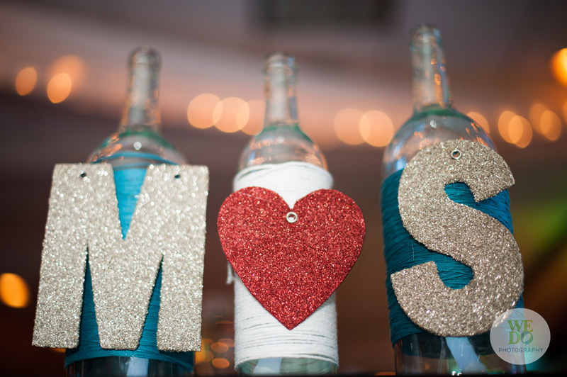 Glitter wedding sign on wine bottles